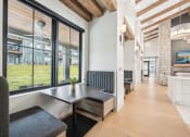 Thumbnail 31 of 53 - a dining room with a table and chairs and a wall of windows at The Garrison Luxury Apartment Homes, Colorado