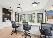 Thumbnail 34 of 53 - an office with chairs and a counter with a large window at The Garrison Luxury Apartment Homes, Fountain, CO