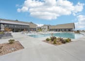 Thumbnail 42 of 53 - a large swimming pool with a building in the background at The Garrison Luxury Apartment Homes, Fountain Colorado