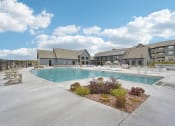 Thumbnail 43 of 53 - swimming pool with buildings in the background at The Garrison Luxury Apartment Homes, Colorado, 80817