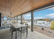 Thumbnail 44 of 53 - a dining area with a table and chairs next to a sliding glass door at The Garrison Luxury Apartment Homes, Colorado, 80817