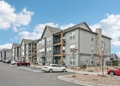 Thumbnail 51 of 53 - a row of apartment buildings with cars parked in front of them at The Garrison Luxury Apartment Homes, Fountain