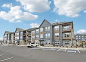Thumbnail 53 of 53 - an empty parking lot in front of an apartment building at The Garrison Luxury Apartment Homes, Colorado, 80817