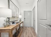 Thumbnail 5 of 53 - a hallway with a desk with a lamp and a white door at The Garrison Luxury Apartment Homes, Colorado, 80817