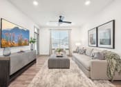 Thumbnail 6 of 53 - a living room with a couch and a coffee table and a ceiling fan at The Garrison Luxury Apartment Homes, Fountain, 80817