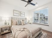 Thumbnail 11 of 53 - a bedroom with a bed and a ceiling fan at The Garrison Luxury Apartment Homes, Colorado