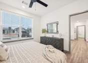 Thumbnail 12 of 53 - a bedroom with a large window and a bed at The Garrison Luxury Apartment Homes, Fountain