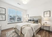 Thumbnail 16 of 53 - a bedroom with a large window and a bed at The Garrison Luxury Apartment Homes, Fountain, CO 80817
