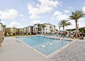 Thumbnail 72 of 115 - A large swimming pool surrounded by palm trees and lounge chairs. at Terrassa Luxury Apartments, St. Augustine