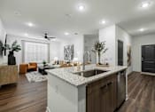 Thumbnail 56 of 115 - A modern kitchen with a large island and wooden floors. at Terrassa Luxury Apartments, Florida, 32084