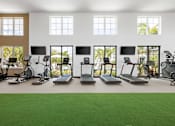 Thumbnail 4 of 68 - A gym with treadmills, exercise bikes, and other equipment.