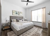 Thumbnail 55 of 68 - A bedroom with a large bed and a ceiling fan.
