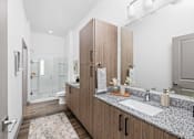Thumbnail 56 of 68 - A bathroom with a sink, mirror, and cabinets.