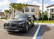 Thumbnail 52 of 68 - A black Mercedes-Benz EQC is parked in a parking spot with a charging station.