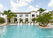 Thumbnail 53 of 68 - A swimming pool in front of a white building with a cross on it.