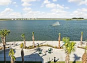 Thumbnail 81 of 83 - A view of a lake with palm trees and a jet ski in the water. at Junction Apartments in Rockledge, FL