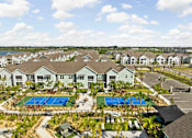 Thumbnail 78 of 83 - A large residential complex with a swimming pool and tennis courts. at Junction Apartments in Rockledge, FL