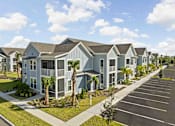 Thumbnail 76 of 83 - A row of houses with a parking lot in front. at Junction Apartments in Rockledge, FL