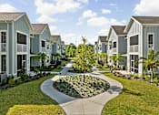 Thumbnail 79 of 83 - A tree in a garden in front of apartment buildings. at Junction Apartments in Rockledge, FL