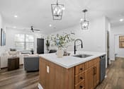 Thumbnail 65 of 83 - A modern kitchen with wooden cabinets and a white countertop. at Junction Apartments in Rockledge, FL