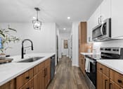 Thumbnail 59 of 83 - A modern kitchen with wooden cabinets and stainless steel appliances. at Junction Apartments in Rockledge, FL