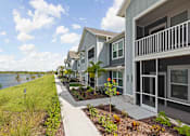 Thumbnail 3 of 83 - A row of houses with a walkway in between. at Junction Apartments in Rockledge, FL