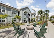 Thumbnail 67 of 83 - A sunny day at a residential area with green chairs and a fountain. at Junction Apartments in Rockledge, FL