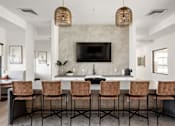 Thumbnail 106 of 108 - A modern kitchen with a bar area and chairs.