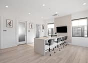 Thumbnail 108 of 108 - A modern office space with a desk, chairs, and a television.