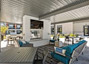 Thumbnail 101 of 108 - A patio with a table and chairs and a television.