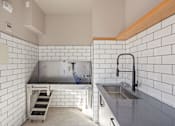 Thumbnail 100 of 108 - A kitchen with a sink and a stainless steel counter.