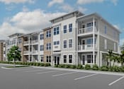 Thumbnail 9 of 13 - A row of modern apartment buildings with a parking lot in front at Verity Luxury Apartment Homes Apartments, Vero Beach