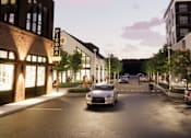 Thumbnail 15 of 45 - A street view with cars and buildings on both sides at The Union Flats at Fishers District, Fishers
