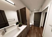 Thumbnail 17 of 34 - A modern bathroom with a white sink and brown cabinetry at Stack at Wheat Ridge Apartments, Apartments, Wheat Ridge, CO