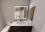 Thumbnail 31 of 34 - A bathroom with a sink, mirror, and toilet at Stack at Wheat Ridge Apartments, Colorado, 80033