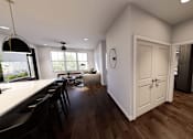 Thumbnail 22 of 34 - A modern kitchen with a dining table and chairs at Stack at Wheat Ridge Apartments, Colorado