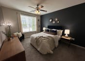 Thumbnail 38 of 56 - a bedroom with a large bed and a ceiling fan at Watermark at Steele Crossing, Fayetteville, 72703