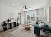 Thumbnail 51 of 108 - a living room with a couch and a ceiling fan at The Maddox Luxury Apartment Homes, Arizona, 85326 