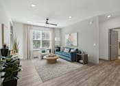 Thumbnail 53 of 108 - a living room with a couch and a coffee table in front of a window at The Maddox Luxury Apartment Homes, Buckeye, AZ  
