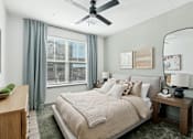 Thumbnail 43 of 108 - a bedroom with a large bed and a ceiling fan at The Maddox Luxury Apartment Homes, Arizona  