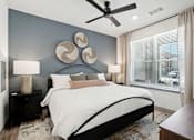 Thumbnail 50 of 108 - a bedroom with a bed and a ceiling fan at The Maddox Luxury Apartment Homes, Arizona  