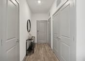 Thumbnail 56 of 108 - a hallway with white walls and white doors and a door to a closet at The Maddox Luxury Apartment Homes, Arizona  