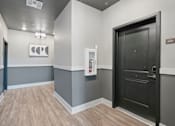 Thumbnail 52 of 108 - a hallway with a black door at The Maddox Luxury Apartment Homes, Buckeye, AZ 85326  