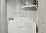 Thumbnail 13 of 108 - a white laundry room with two washes and a dryer at The Maddox Luxury Apartment Homes, Arizona, 85326 