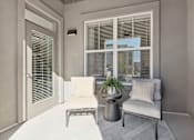 Thumbnail 46 of 108 - a living room with a couch and a table and a window at The Maddox Luxury Apartment Homes, Buckeye, AZ 85326  