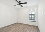 Thumbnail 61 of 108 - an empty room with a ceiling fan and a window at The Maddox Luxury Apartment Homes, Buckeye  