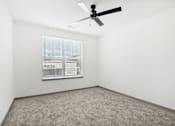 Thumbnail 81 of 108 - a room with a ceiling fan and a window at The Maddox Luxury Apartment Homes, Buckeye  