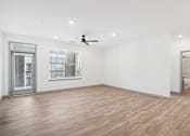 Thumbnail 75 of 108 - an empty living room with white walls and a ceiling fan at The Maddox Luxury Apartment Homes, Buckeye, AZ  