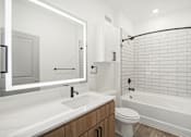 Thumbnail 91 of 108 - a white bathroom with a tub and a toilet and a sink at The Maddox Luxury Apartment Homes, Arizona