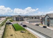 Thumbnail 18 of 38 - an aerial view of an apartment complex with cars parked in a parking lot at Upland Flats, Colorado Springs, CO, 80922